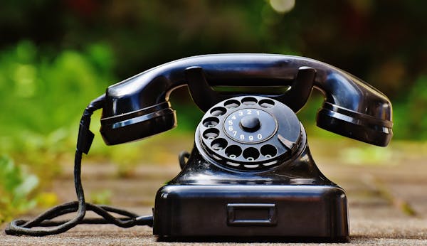 Vintage black rotary phone symbolizing outdated communication methods.